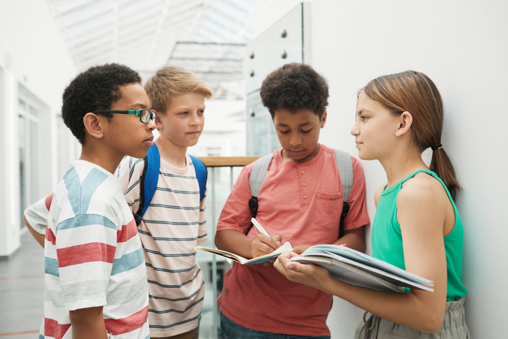 A group of multicultural students discussing and studying together indoors.